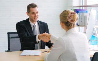 Job seeker and manager handshake in job interview meeting at corporate office. The young interviewee seeking for a professional career job opportunity . Human resources and recruitment concept.