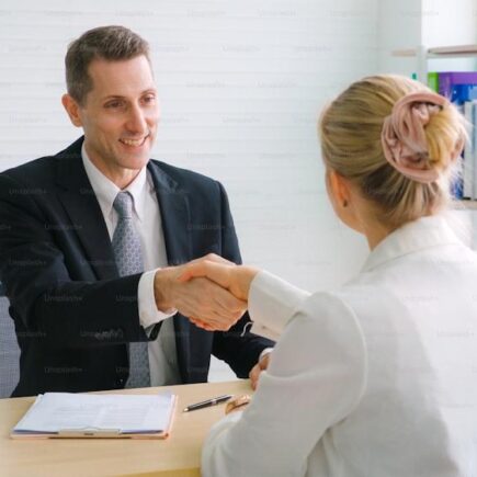 Job seeker and manager handshake in job interview meeting at corporate office. The young interviewee seeking for a professional career job opportunity . Human resources and recruitment concept.