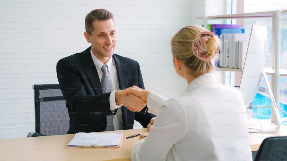 Job seeker and manager handshake in job interview meeting at corporate office. The young interviewee seeking for a professional career job opportunity . Human resources and recruitment concept.